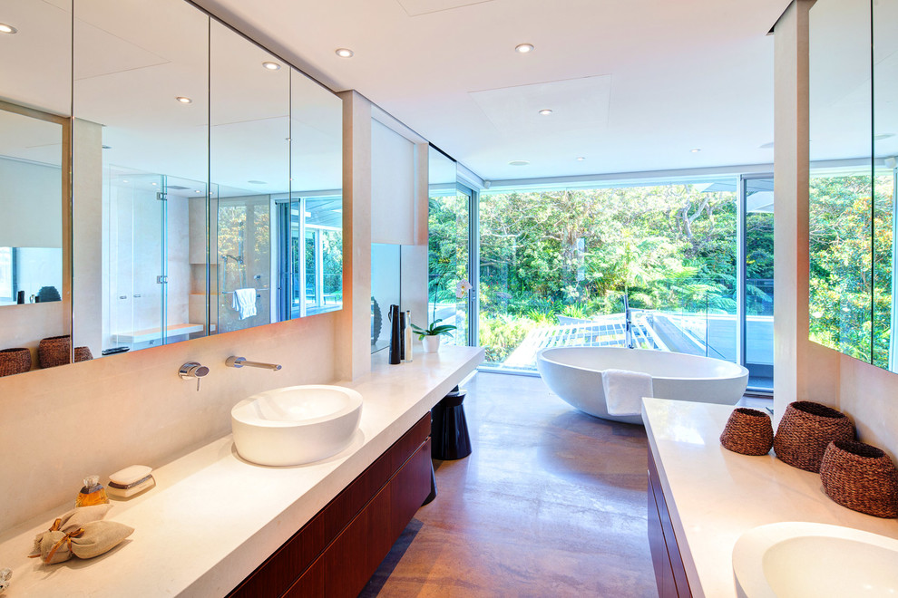 Design ideas for a large modern master bathroom in Sydney with dark wood cabinets, a freestanding tub, a double shower, beige tile, stone tile, beige walls, marble floors and engineered quartz benchtops.