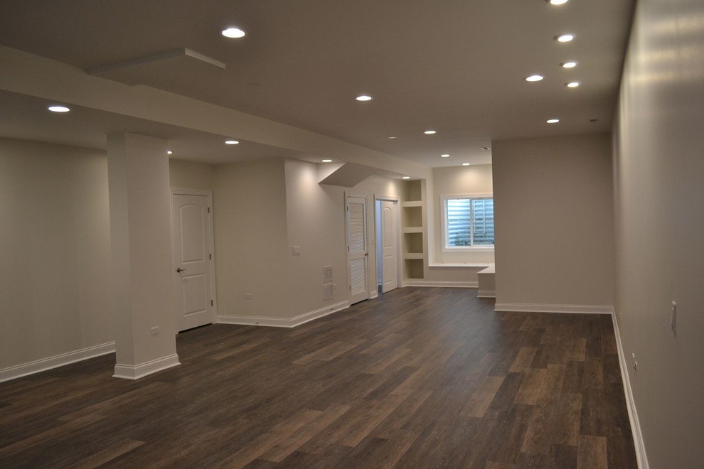 Design ideas for a mid-sized traditional fully buried basement in Chicago with white walls, dark hardwood floors and brown floor.