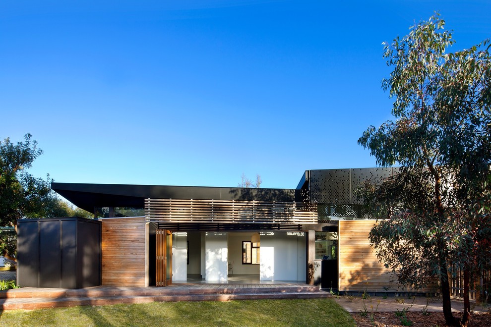 Inspiration for a modern exterior in Melbourne with wood siding.