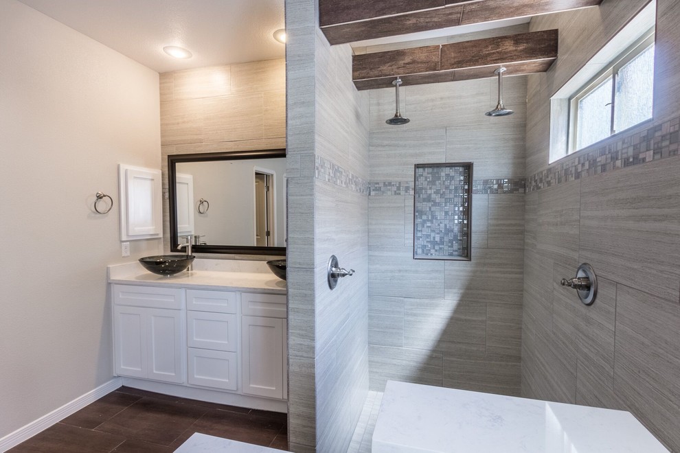 Double shower - large transitional master brown tile and ceramic tile ceramic tile double shower idea in Austin with flat-panel cabinets, white cabinets, a one-piece toilet, gray walls, a vessel sink and granite countertops