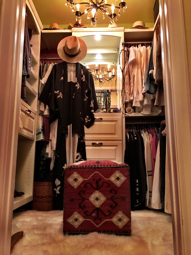 Mid-sized country women's walk-in wardrobe in Los Angeles with raised-panel cabinets and white cabinets.