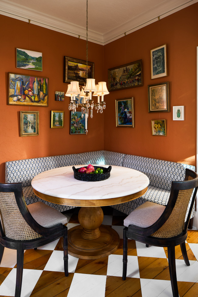 This is an example of a mid-sized traditional dining room in Columbus with orange walls, medium hardwood floors and brown floor.