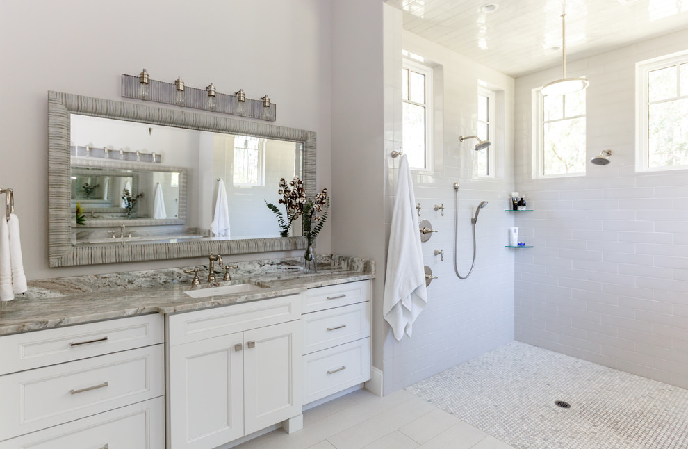 This is an example of a large transitional master bathroom in Jacksonville with white cabinets, white tile, subway tile, porcelain floors, quartzite benchtops, recessed-panel cabinets, a curbless shower, grey walls, an undermount sink, grey floor, an open shower and grey benchtops.