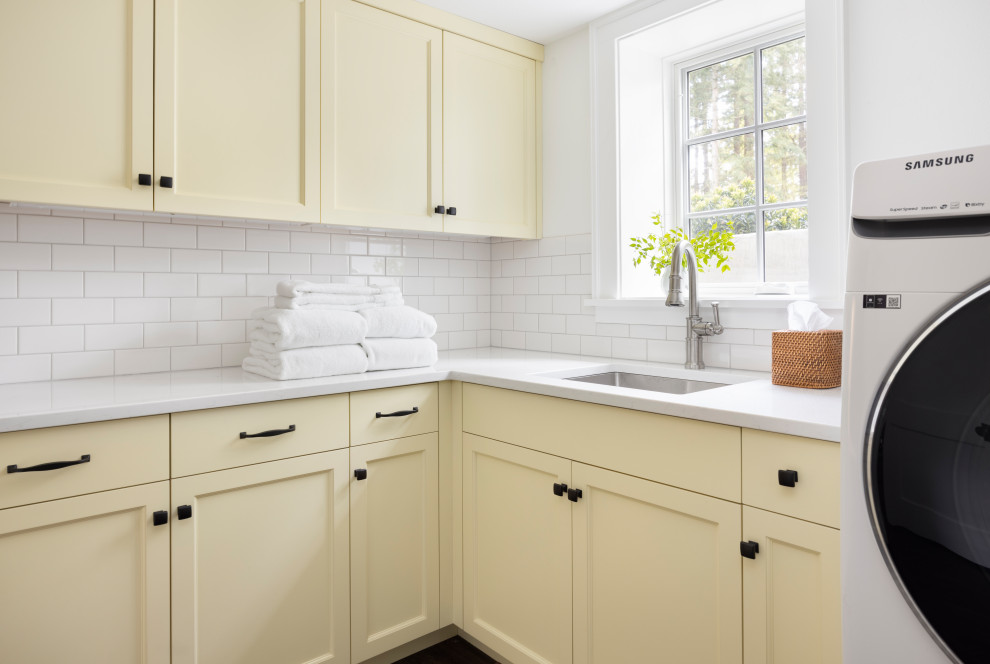 Inspiration for a medium sized traditional l-shaped separated utility room in Portland with a submerged sink, beaded cabinets, yellow cabinets, engineered stone countertops, white splashback, ceramic splashback, laminate floors, a side by side washer and dryer, white worktops and wallpapered walls.