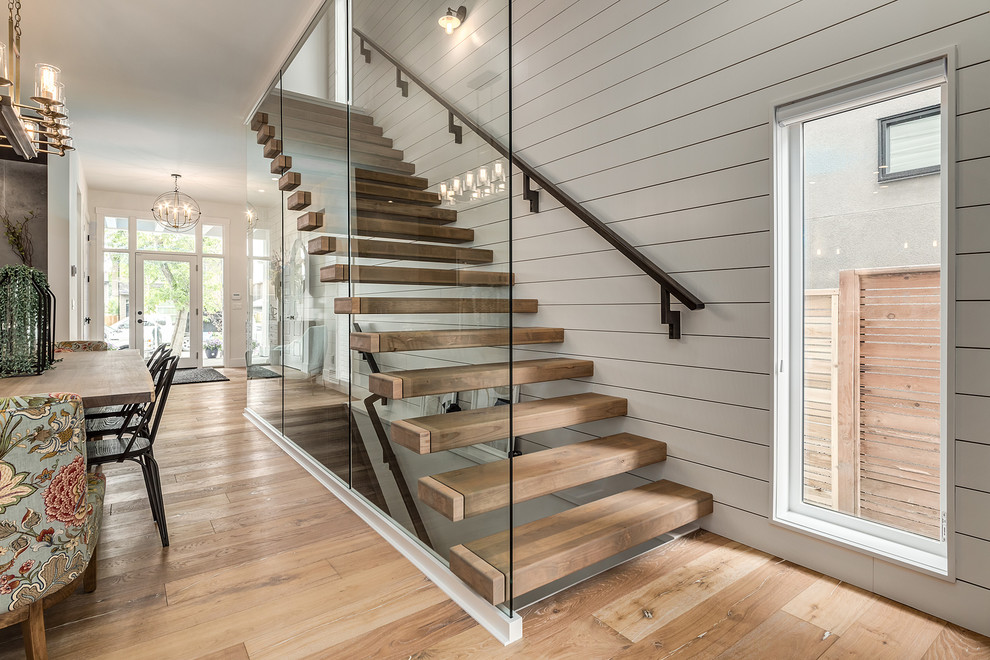 Inspiration for a mid-sized country wood floating staircase in Calgary with open risers and wood railing.