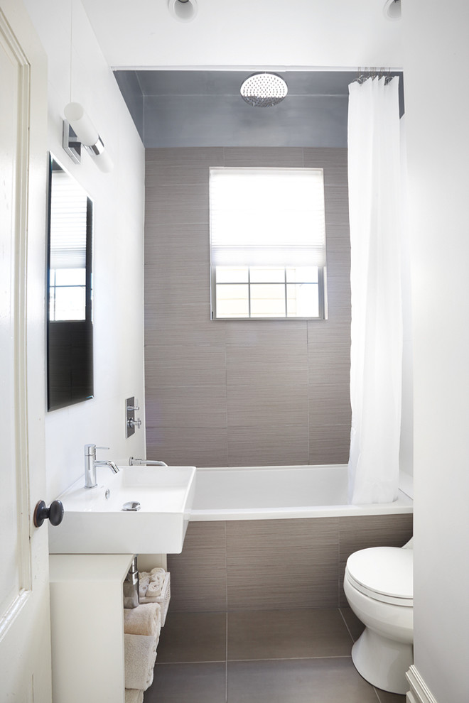 This is an example of a contemporary bathroom in San Francisco with a vessel sink, open cabinets, a drop-in tub, a shower/bathtub combo and brown tile.