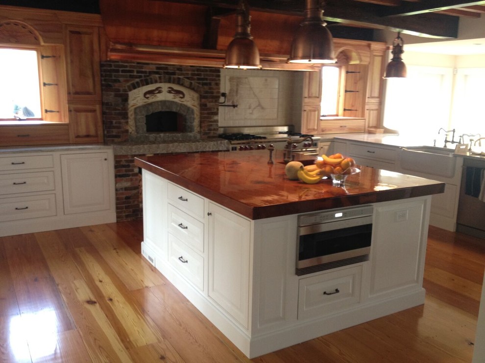 Open concept kitchen - large rustic l-shaped light wood floor open concept kitchen idea with shaker cabinets, white cabinets, stainless steel appliances and an island