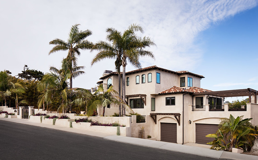 This is an example of an expansive mediterranean split-level stucco beige exterior in San Diego.