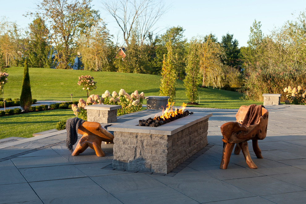 Inspiration for an expansive contemporary backyard patio in Philadelphia with a fire feature, concrete pavers and no cover.