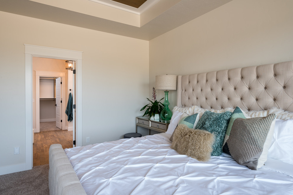 Inspiration for a mid-sized transitional master bedroom in Boise with beige walls, carpet and beige floor.