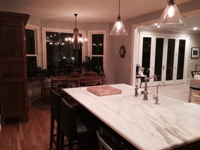 Transitional kitchen photo with shaker cabinets, white cabinets and an island