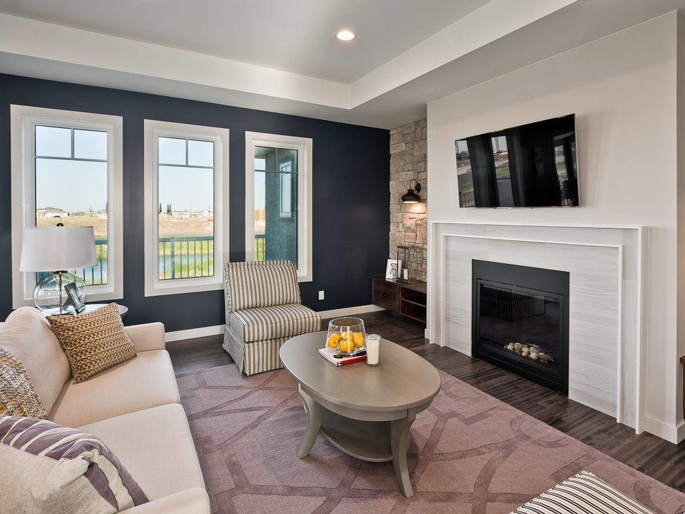 Transitional living room in Other with blue walls, a standard fireplace and a wall-mounted tv.