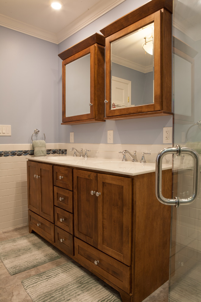 Design ideas for a mid-sized traditional master bathroom in New York with an integrated sink, recessed-panel cabinets, dark wood cabinets, granite benchtops, a corner shower, a two-piece toilet, white tile, subway tile, blue walls and marble floors.