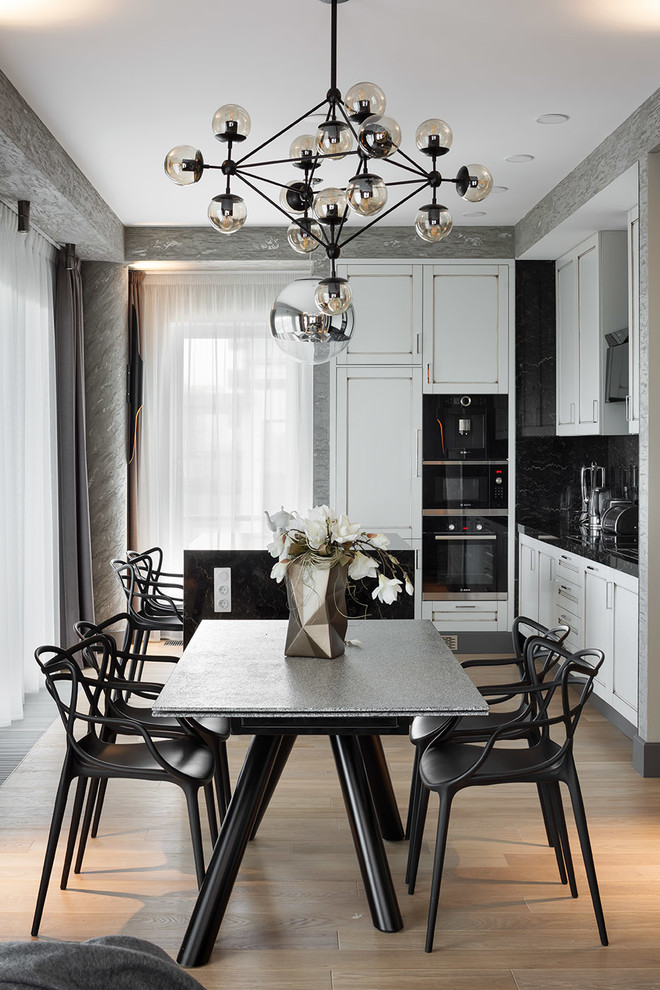 Photo of a contemporary open plan dining in Moscow with grey walls, light hardwood floors and beige floor.