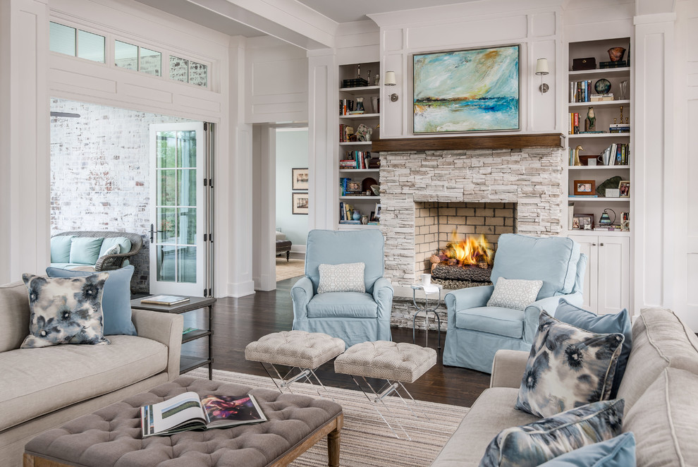 Large country open concept living room in Nashville with white walls, dark hardwood floors, a standard fireplace, a stone fireplace surround, no tv and brown floor.