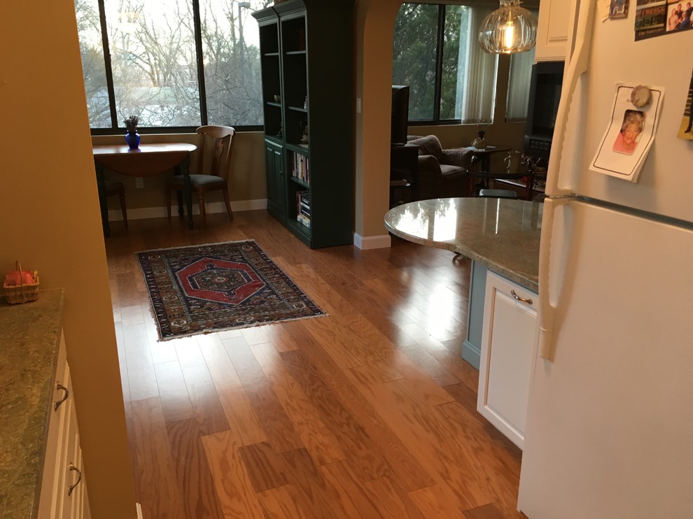 Kitchen - transitional u-shaped medium tone wood floor kitchen idea in Boston with a drop-in sink, raised-panel cabinets, white cabinets, granite countertops, green backsplash, glass tile backsplash, white appliances, a peninsula and green countertops