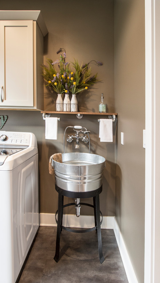 This is an example of a mid-sized traditional utility room in Other with flat-panel cabinets, beige cabinets, laminate benchtops and a side-by-side washer and dryer.
