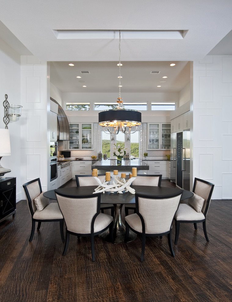 This is an example of a transitional kitchen/dining combo in Austin with brown floor.