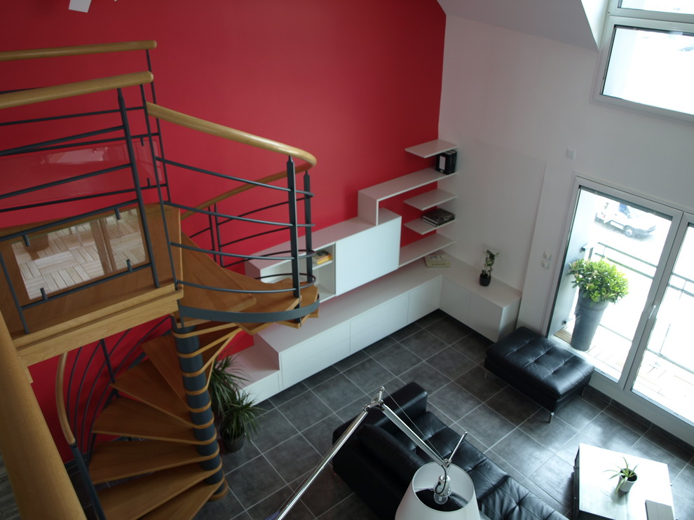 Inspiration for a large contemporary open concept living room in Rennes with a library, red walls, ceramic floors, no fireplace and a concealed tv.