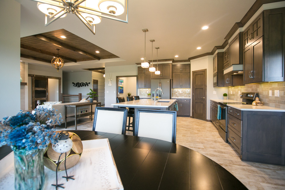 Inspiration for a large rustic l-shaped vinyl floor eat-in kitchen remodel with a double-bowl sink, recessed-panel cabinets, dark wood cabinets, quartzite countertops, multicolored backsplash, glass tile backsplash, stainless steel appliances and an island