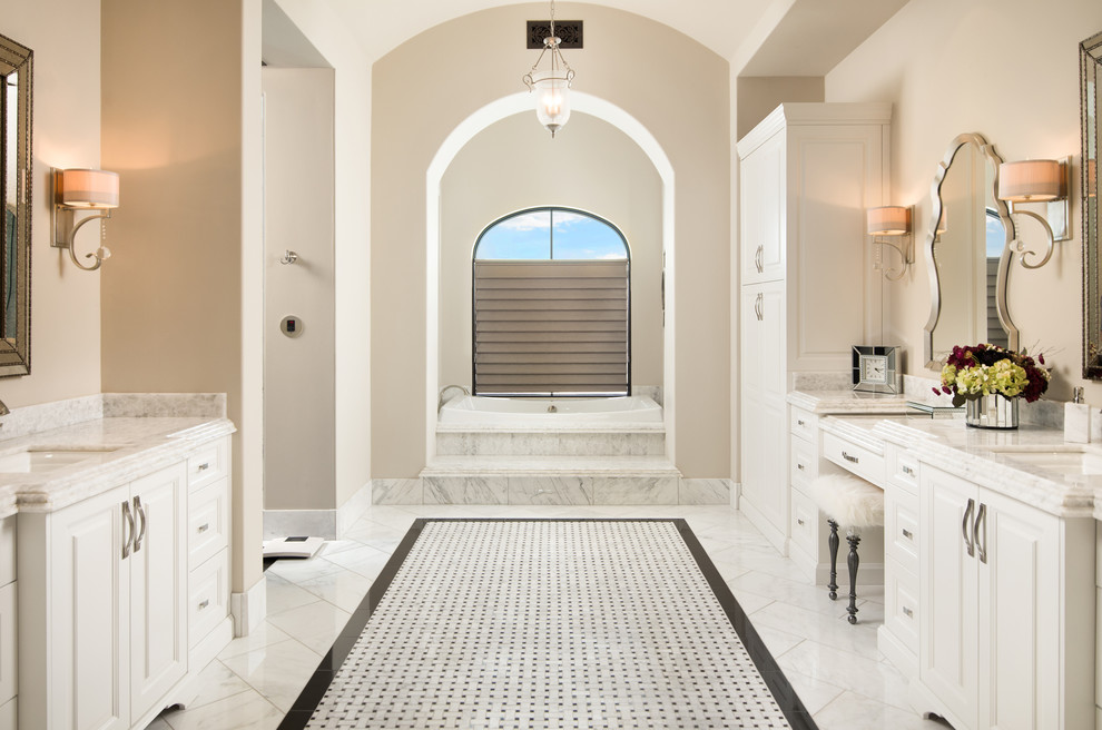 Expansive mediterranean master bathroom in Phoenix with furniture-like cabinets, medium wood cabinets, a one-piece toilet, beige tile, mosaic tile, white walls, porcelain floors, a vessel sink, onyx benchtops and white floor.