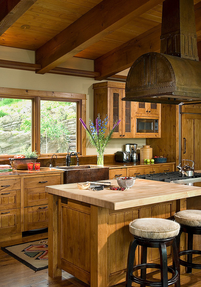 Eat-in kitchen - mid-sized rustic dark wood floor eat-in kitchen idea with a farmhouse sink, recessed-panel cabinets, medium tone wood cabinets, wood countertops, stainless steel appliances and an island