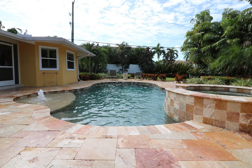 Inspiration for a large transitional backyard tile and custom-shaped hot tub remodel in Miami