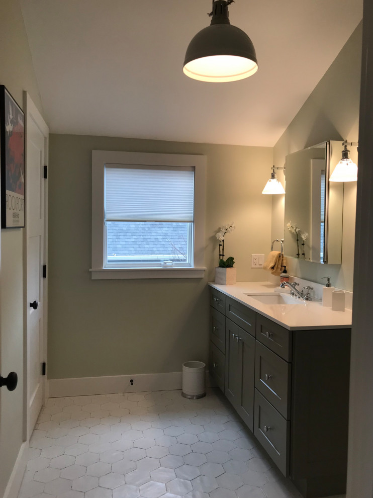 This is an example of a mid-sized beach style master bathroom with shaker cabinets, green cabinets, white tile, subway tile, green walls, ceramic floors, an undermount sink, engineered quartz benchtops, beige floor, a hinged shower door, white benchtops, a laundry, a single vanity and vaulted.