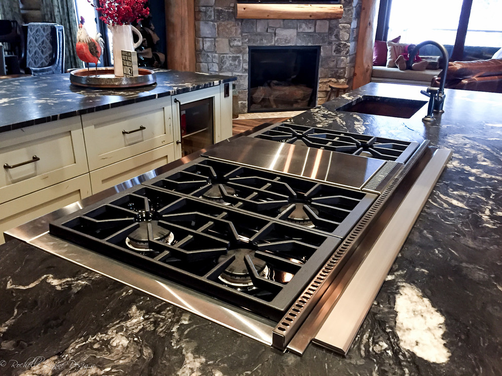 Inspiration for a rustic l-shaped medium tone wood floor open concept kitchen remodel in Calgary with shaker cabinets, distressed cabinets, granite countertops, stainless steel appliances, two islands and an undermount sink