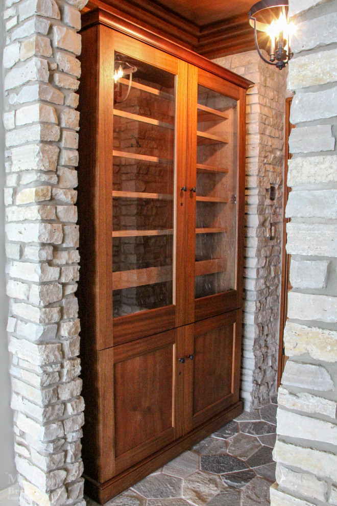 Photo of a large traditional wine cellar in Other with slate floors and display racks.