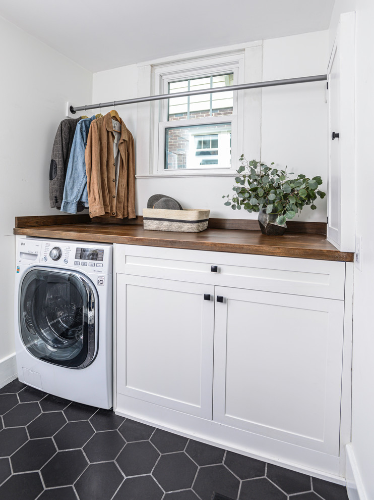Design ideas for a laundry room in Nashville with raised-panel cabinets, white cabinets, wood benchtops, white walls, an integrated washer and dryer and brown benchtop.