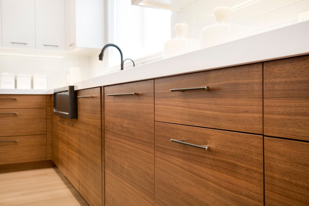 Photo of a contemporary kitchen in Salt Lake City with flat-panel cabinets, medium wood cabinets and with island.