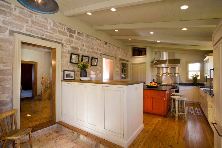 Inspiration for a mid-sized arts and crafts l-shaped separate kitchen in Salt Lake City with a farmhouse sink, recessed-panel cabinets, white cabinets, white appliances, medium hardwood floors and multiple islands.