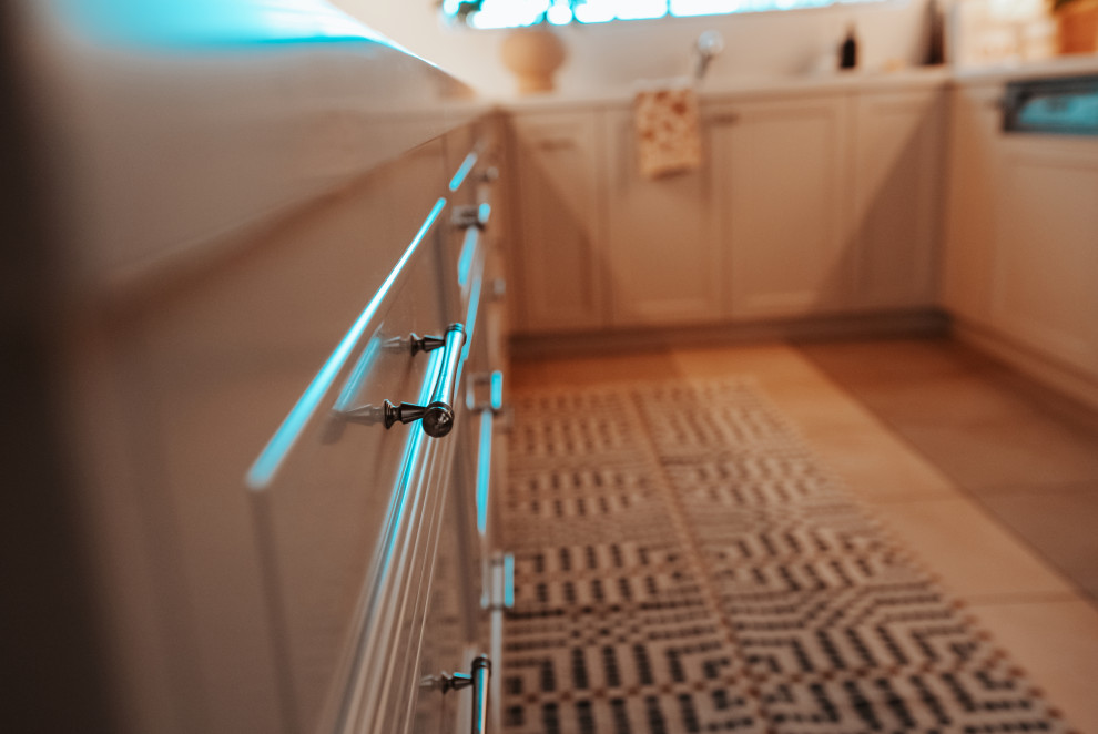 Design ideas for a large mediterranean u-shaped eat-in kitchen in Sydney with a double-bowl sink, beaded inset cabinets, beige cabinets, quartz benchtops, beige splashback, engineered quartz splashback, stainless steel appliances, ceramic floors, no island, beige floor, beige benchtop and timber.
