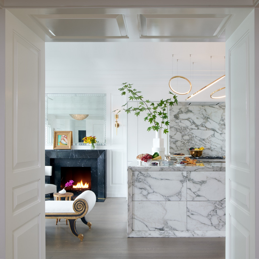 Inspiration for a large transitional single-wall open plan kitchen in DC Metro with an undermount sink, flat-panel cabinets, white cabinets, marble benchtops, marble splashback, panelled appliances, light hardwood floors and with island.