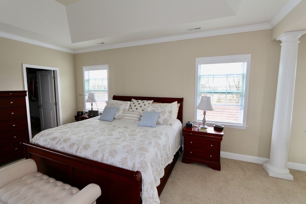 Design ideas for a large traditional master bedroom in Philadelphia with beige walls and carpet.