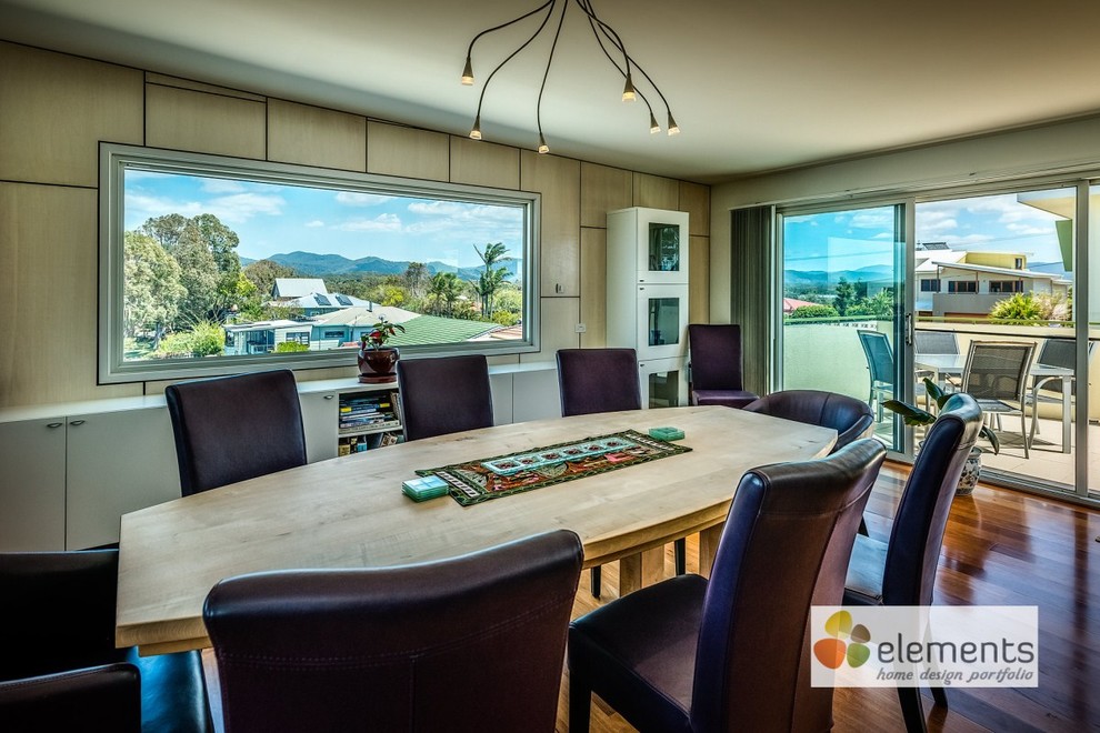 Design ideas for a mid-sized contemporary open plan dining in Sydney with medium hardwood floors.