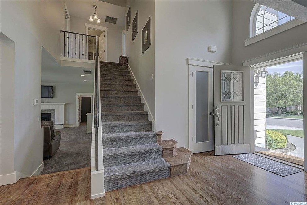 Front door - transitional light wood floor and brown floor front door idea in Seattle with gray walls and a brown front door