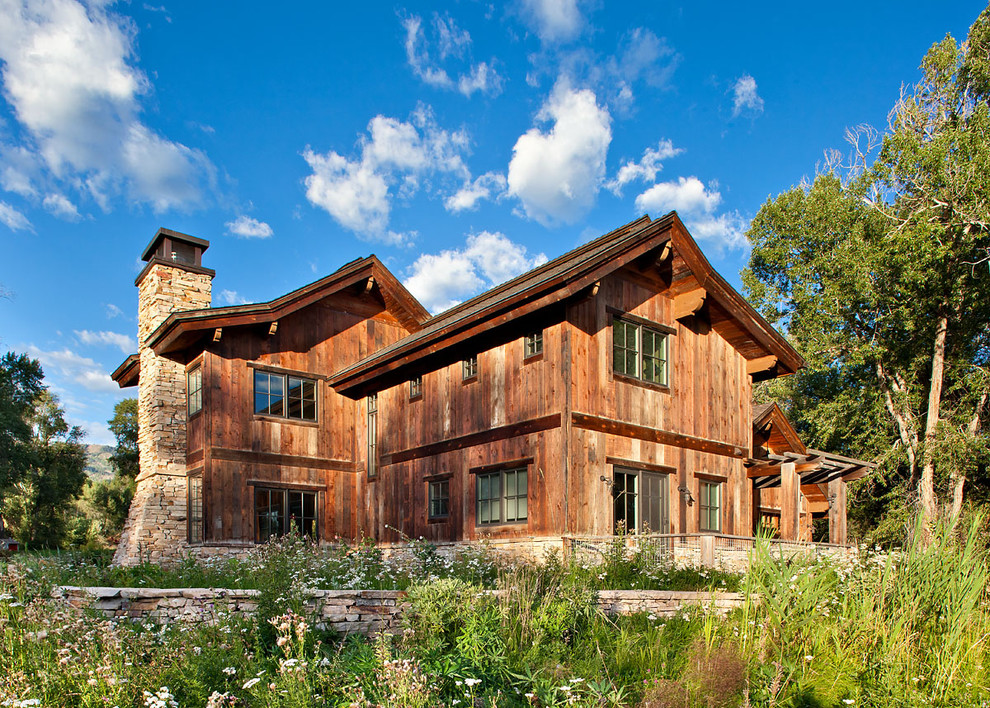 Photo of a country two-storey exterior in Salt Lake City with wood siding.