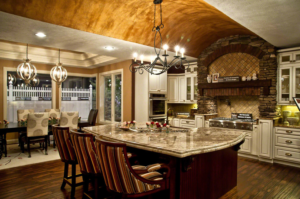 Inspiration for a large transitional u-shaped dark wood floor open concept kitchen remodel in Cleveland with beaded inset cabinets, white cabinets, granite countertops, beige backsplash, stainless steel appliances, metallic walls and an island