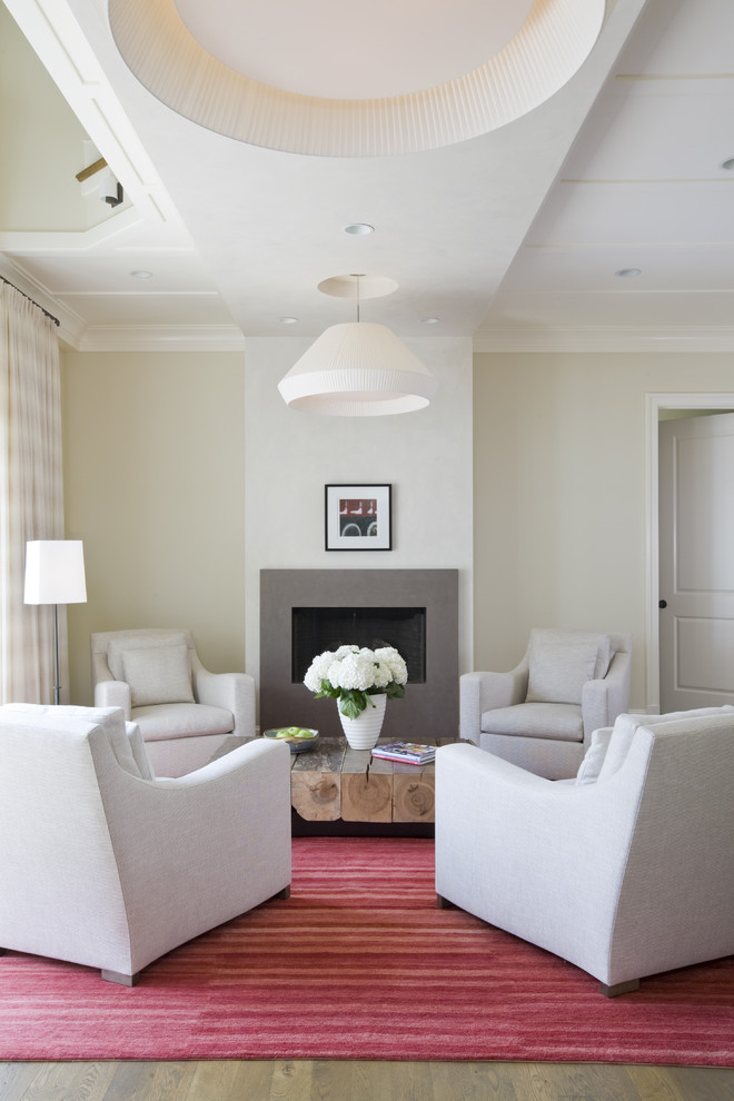This is an example of a contemporary living room in DC Metro with beige walls and a standard fireplace.