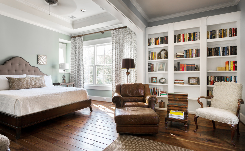 Example of a classic brown floor bedroom design in Houston with blue walls