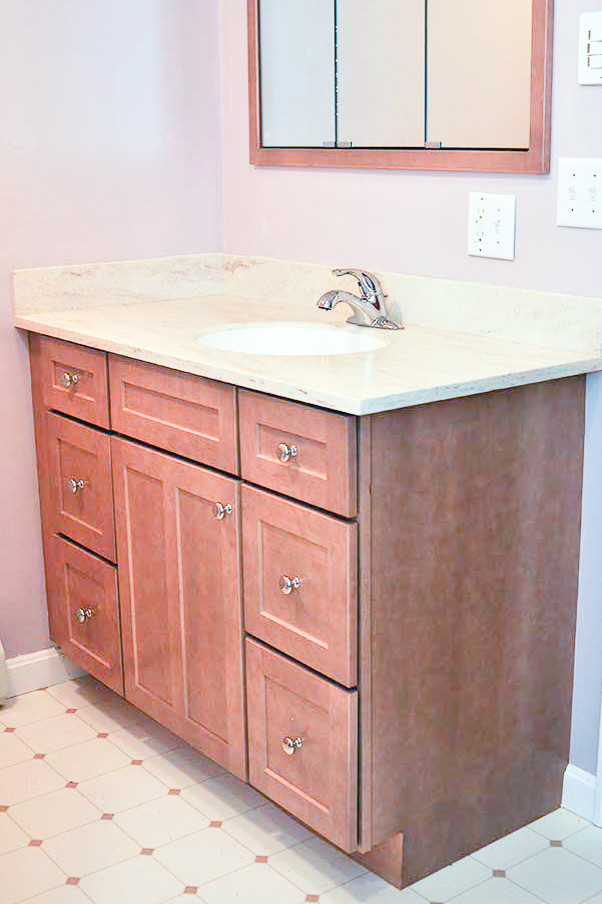 This is an example of a mid-sized traditional 3/4 bathroom in Boston with an alcove shower, a two-piece toilet, recessed-panel cabinets, brown cabinets, granite benchtops, pink walls, linoleum floors, pink floor, an open shower, an alcove tub, white tile and an undermount sink.