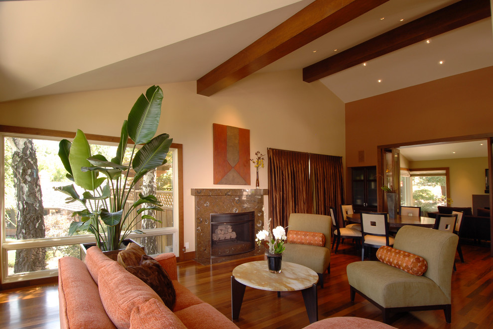 Photo of a contemporary open concept family room in San Francisco with beige walls, dark hardwood floors, a standard fireplace, no tv and brown floor.