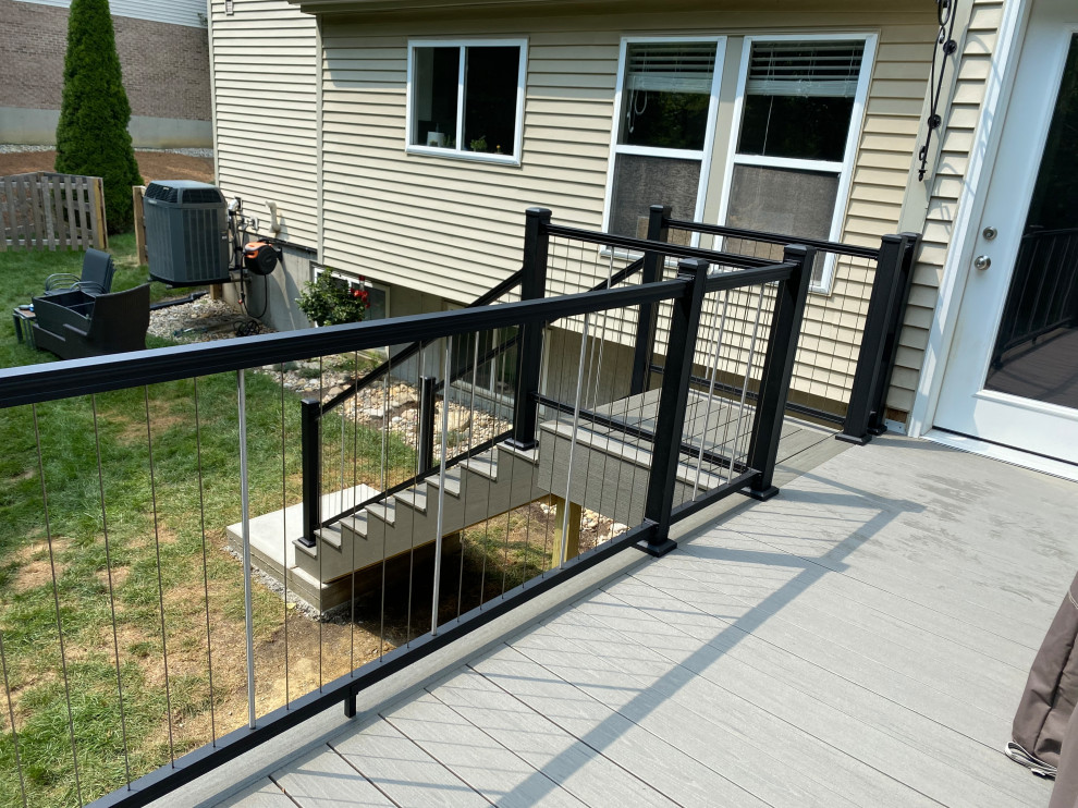 Large transitional backyard second story metal railing deck photo in Cincinnati