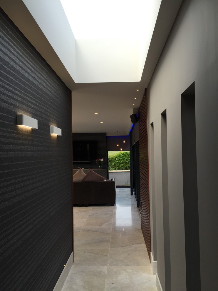 This is an example of a mid-sized contemporary hallway in Cheshire with black walls and marble floors.