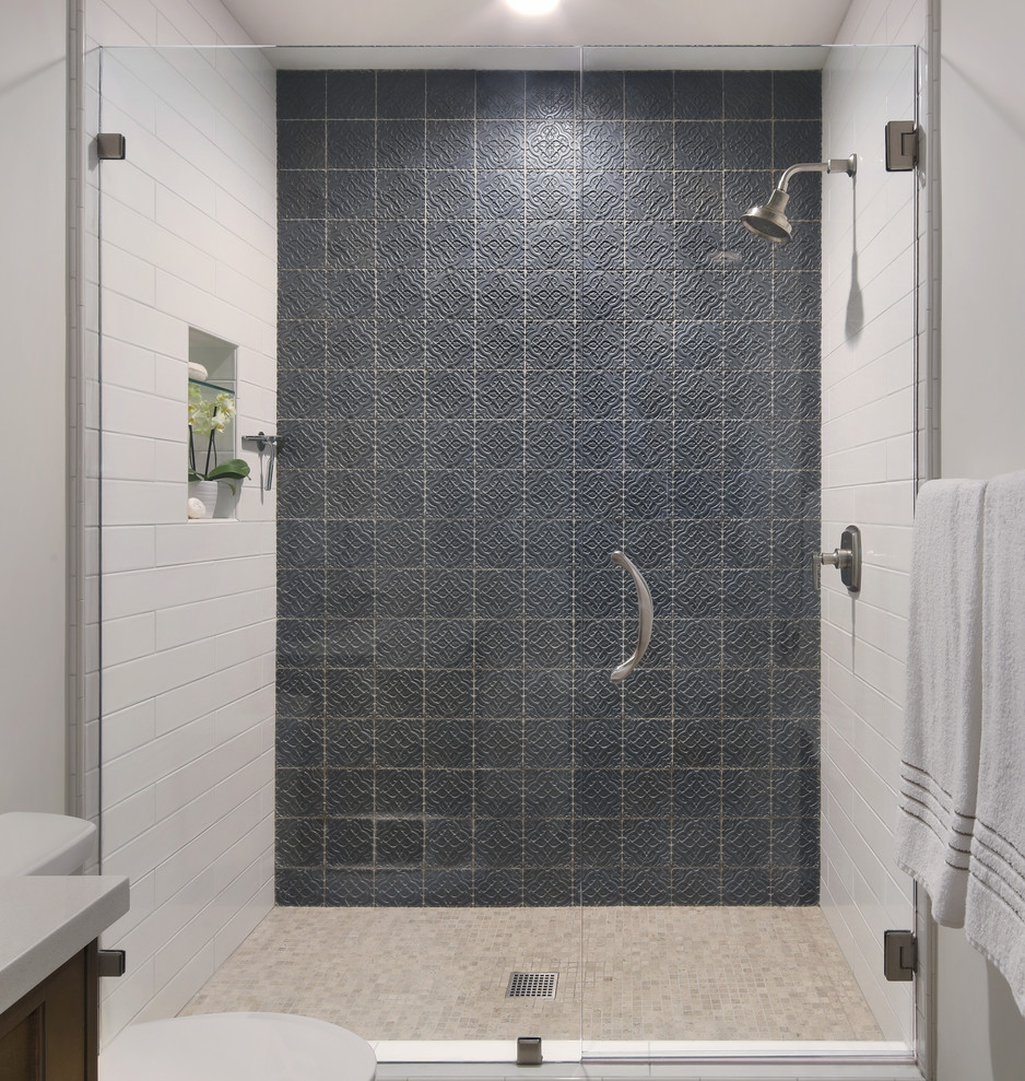 Mid-sized mediterranean kids bathroom in Orange County with shaker cabinets, medium wood cabinets, an alcove shower, ceramic tile, white walls, limestone floors, a wall-mount sink, engineered quartz benchtops, grey floor, a hinged shower door and beige benchtops.