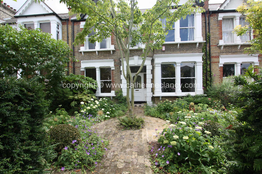 Photo of a shabby-chic style garden in London.