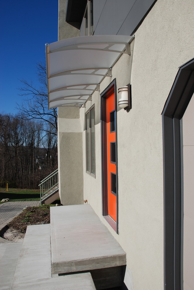 This is an example of a mid-sized modern two-storey exterior in Philadelphia with concrete fiberboard siding.