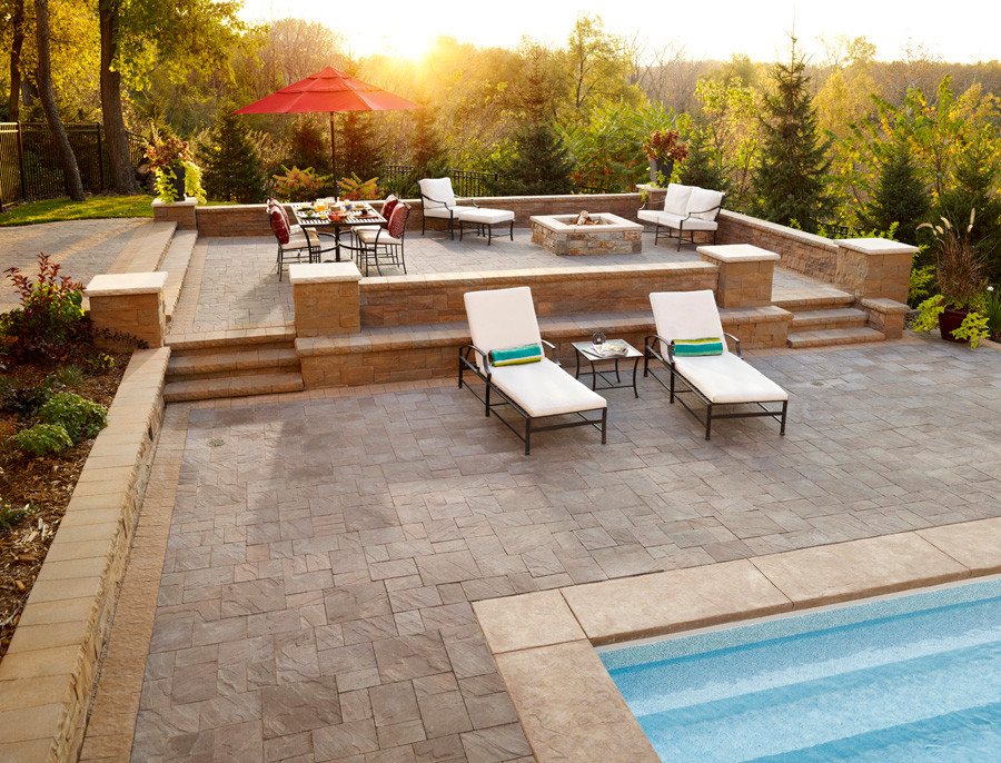 This is an example of a large contemporary patio in Minneapolis with a water feature, concrete pavers and no cover.